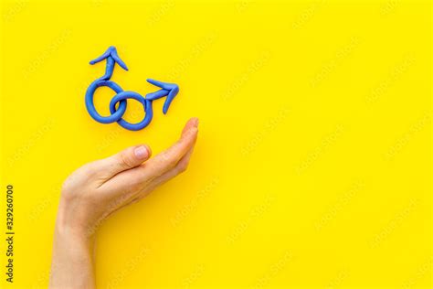 Lgbt Concept Male Mars Symbol In Hands On Yellow Background Top Down