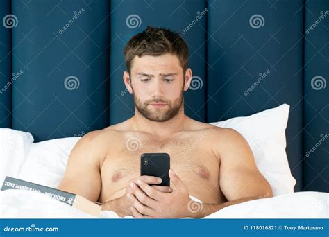 Shirtless Hunky Man With Beard Lies Naked In Bed Royalty Free Stock