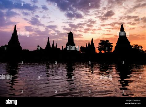 Landscape silhouette of Wat Chaiwatthanaram during sunset next to the Chao Phraya River is ...