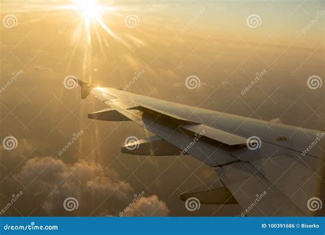 Airline Wing In The Sunset Stock Photo Image Of Clouds 100391686