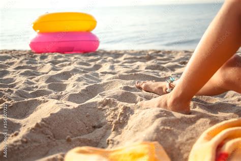 Cropped Photo Of The Leg Of Tan Girl Relax On The Beach And Take