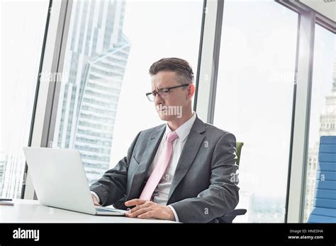Mature Businessman Using Laptop In Office Stock Photo Alamy