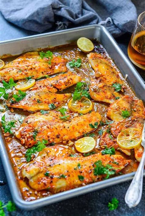 Baked Tilapia O A Baking Tray Along With A Glass Of Wine Baked Tilapia Fillets Baked Tilapia