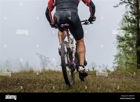 Back Male Mountain Bike Cyclist Riding On Forest Trail Drops Dirt On