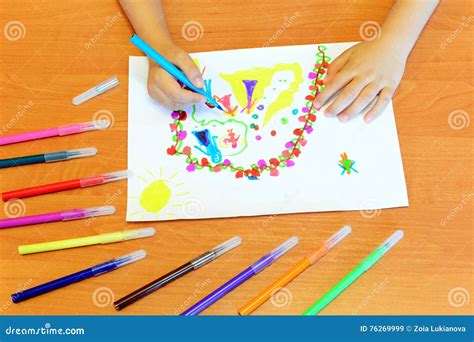 Small Girl Draws Felt Pens. Child Holds a Blue Felt Pen in Hand and ...