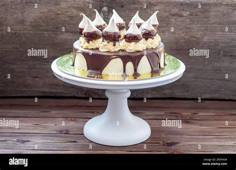 Birthday Cheesecake Decorated With Melted Dark Chocolate Sauce Meringues And Butter Cream