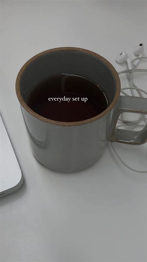 There Is A Cup Of Coffee And Headphones On The Table Next To An Apple