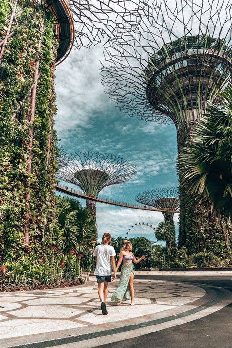 Two People Walking Through The Gardens By The Bay In Singapore With