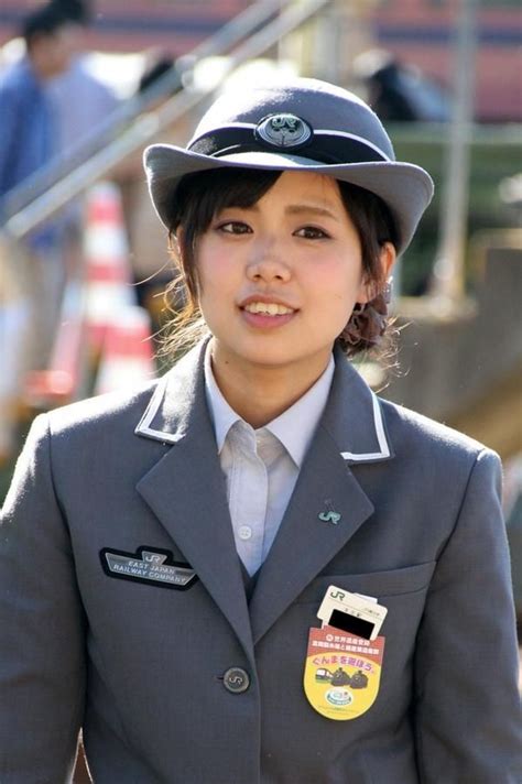 A Woman In Uniform Standing Next To Some Stairs