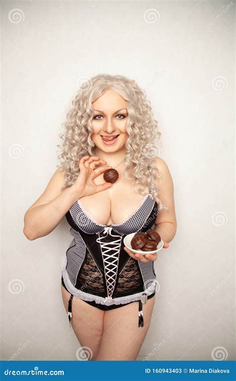 Portrait Of Beautiful Plus Size Curly Young Blond Woman Posing On White With Marshmallow In