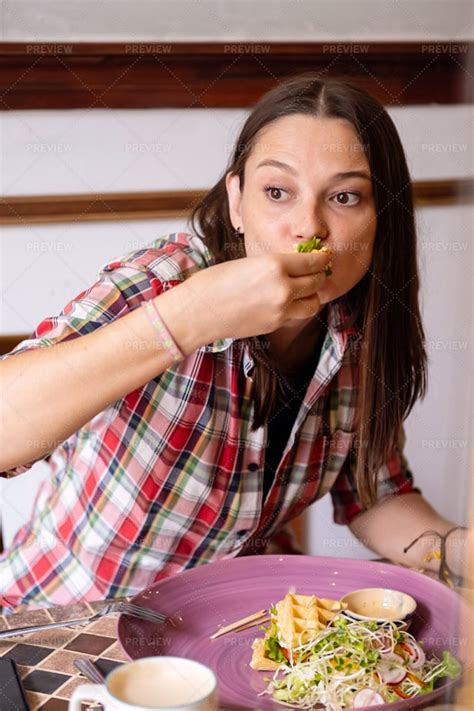 Woman Making Funny Face While Eating - Stock Photos | Motion Array