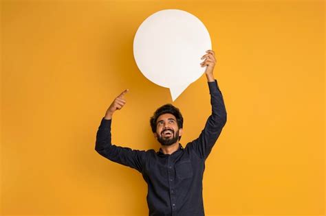 Premium Photo Cheerful Excited Indian Man Pointing At Blank Speech