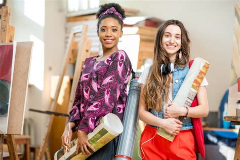 Young Creative Student With Colorful Lamps And Books Stock Photo