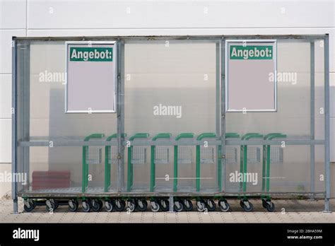 A Plastic Shelter With Trolley Outside In Front Of The Entrance Of A