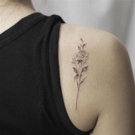 Fine Line Rose Tattoo On The Right Shoulder Blade