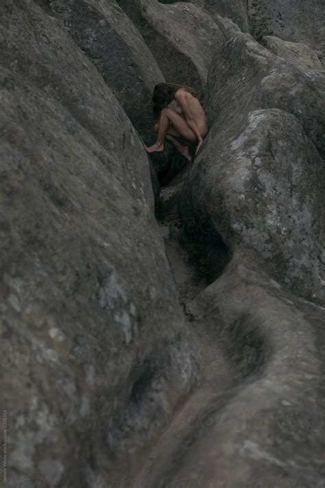 Aesthetic Nude Among Stones That Are Curved By Stocksy Contributor