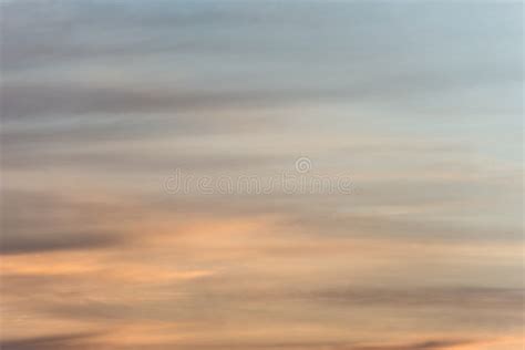 Sunset Sky Background With A Golden Orange Glow On A Hazy Clouds Stock