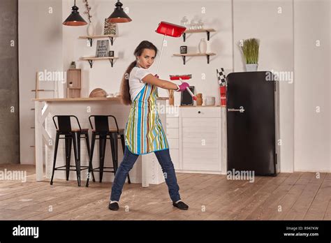 Funny Picture Of Brunette Holding Scoop And Broom In Hands She