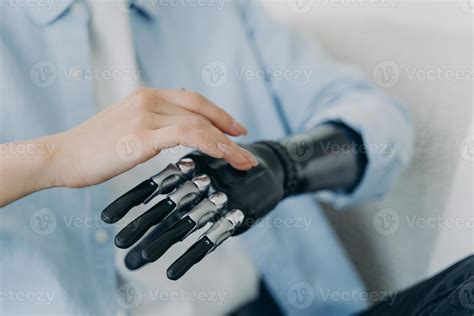 Hands Of Handicapped Girl Setting Up Her Bionic Arm And Pressing