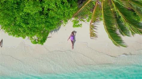 Aerial View Of Slim Woman Sunbathing Lying On A Beach In Thoddoo