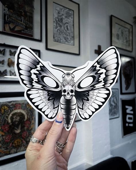 A Person Holding Up A Sticker With A Butterfly On It S Face In Front Of