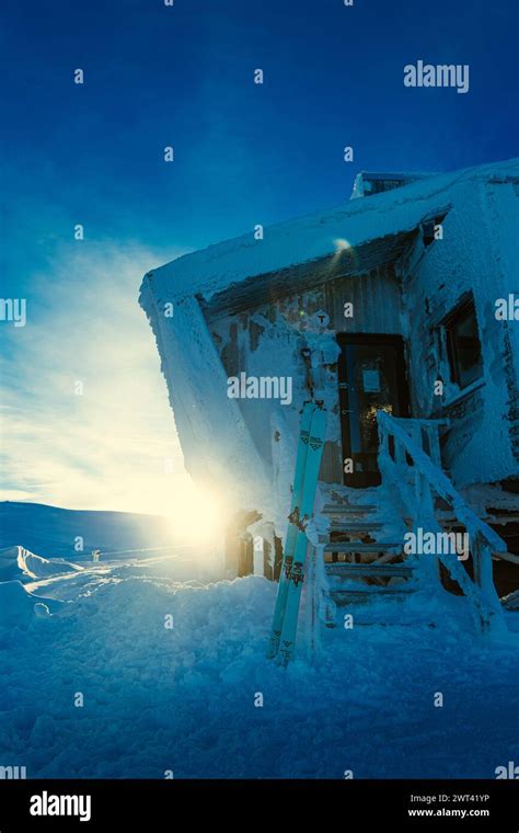 A Snow Covered Hut With A Ramp Leading To The Second Floor In A Wintry