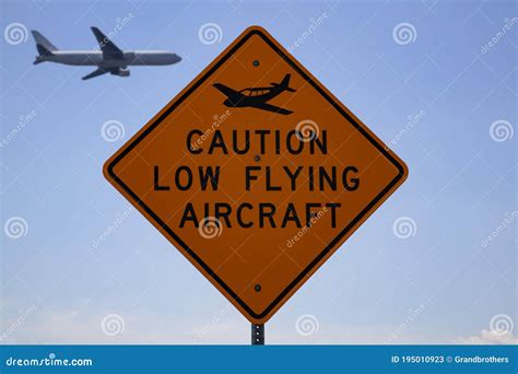 Caution Low Flying Aircraft Sign With An Aircraft In The Background