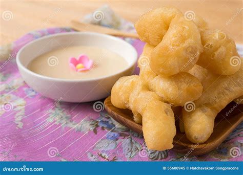 Deep Fried Doughstick And Condensed Milk For Dipping On Wood Tab Stock