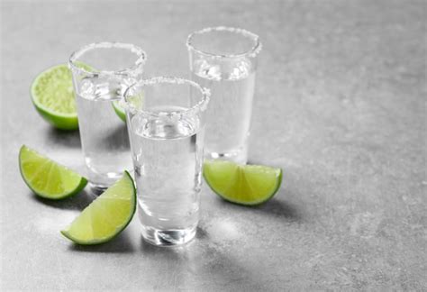 Premium Photo Mexican Tequila Shots With Salt And Lime Slices On Grey