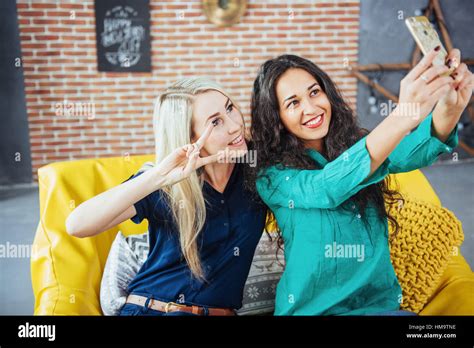 Two Beautiful Young Woman Doing Selfie In A Cafe Best Friends Girls Together Having Fun Posing