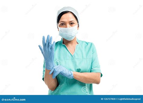 Female Asian Surgeon Wearing Medical Gloves And Looking At Camera Stock