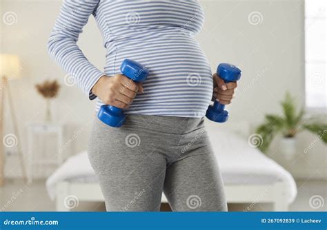 Active Pregnant Woman Doing Exercises with Dumbbells during Fitness ...