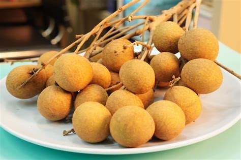 Premium Photo | Sweet fruit a bunch of longan on a plate longan ...