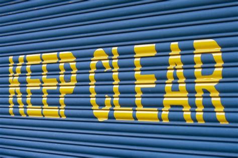 Premium Photo | Yellow keep clear sign on blue shutter