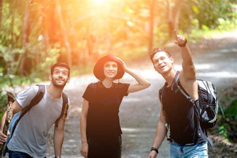 Group Of Friends Hiking Together Talk Happy While Hiking Up The