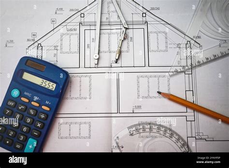Workplace Of Architect Designing Blueprint Of Building Using Calculator