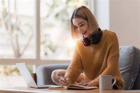 Attractive Asian Woman Resting Comfortable Living Room And Using Laptop