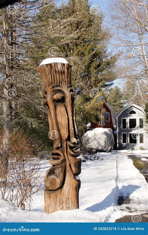 Faces Of A Totem Pole In The Direct Sunlight With Snow Atop Editorial