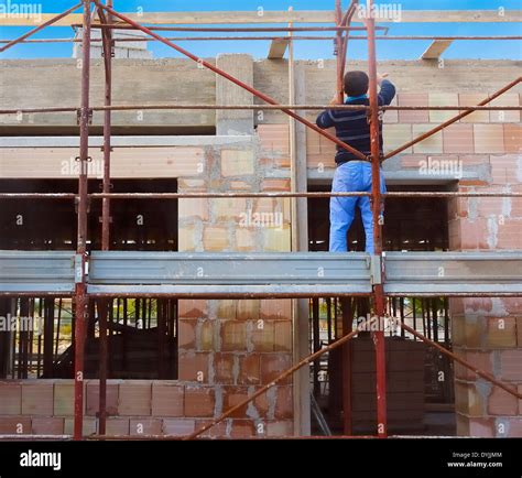 Worker On Scaffold Building Masonry Clay Blocks Stock Photo Alamy