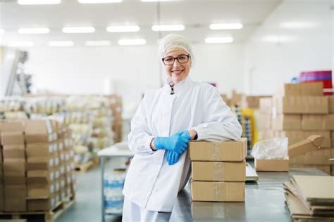 Premium Photo Smiling Female Worker Leaning On Boxes Warehouse Interior