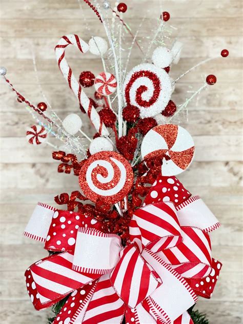 A Red And White Christmas Tree With Candy Canes