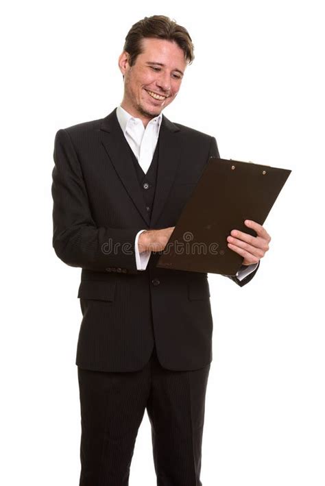 Happy Caucasian Businessman Reading Clipboard While Smiling Stock Image