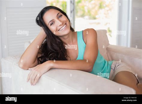 Pretty Brunette Sitting On The Armchair Stock Photo Alamy