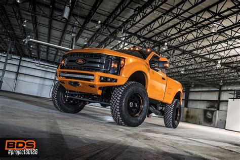 An Orange Truck Is Parked In A Garage