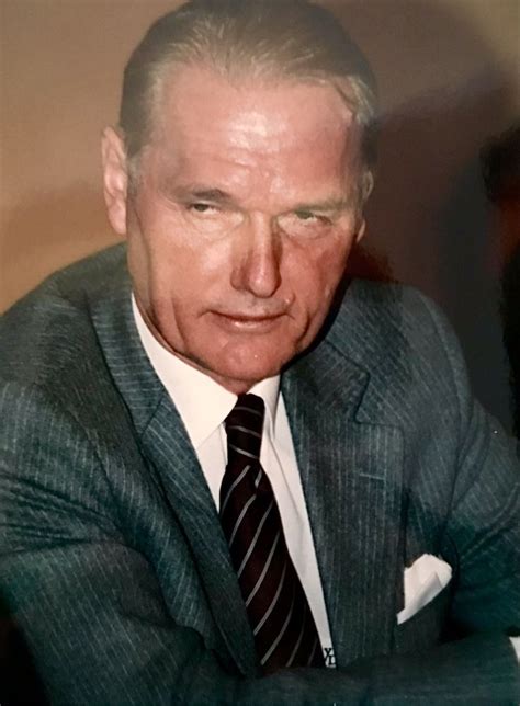 An Older Man Wearing A Suit And Tie