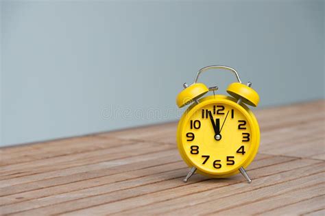 Retro Alarm Clock With Five Minutes To Twelve O Clock Stock Photo