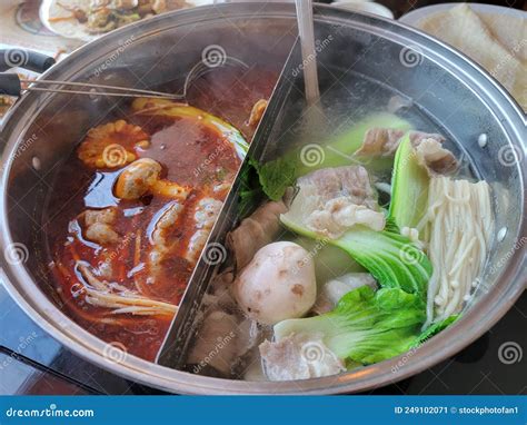 Chinese Hot Pot With Spicy And Regular Broth And Meat And Vegetables Stock Image Image Of