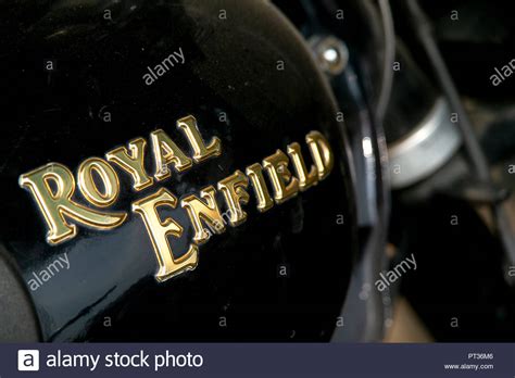 A Close Up Of The Gold Lettering Of The Famous Motorbike Brand Royal Enfield Badge On The Fuel