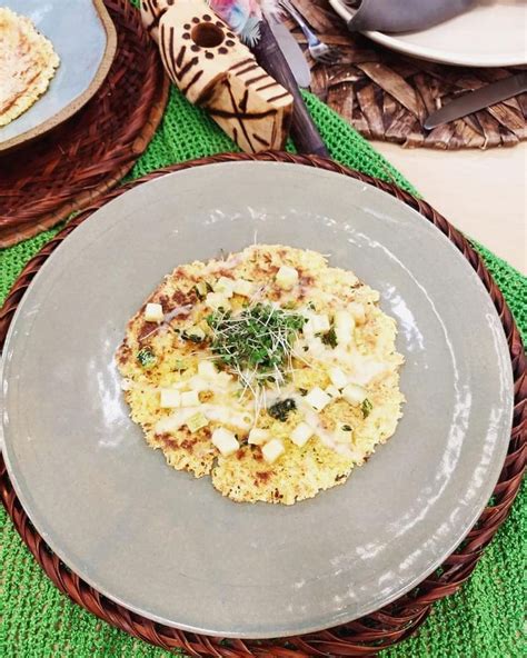 A Plate With Food On It Sitting On A Green Place Mat Next To Other