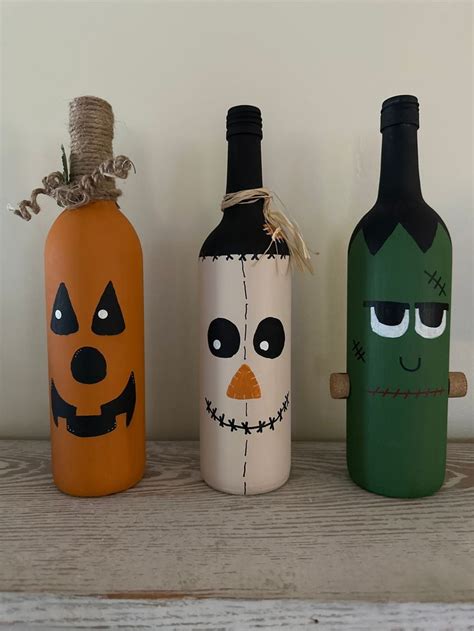 Three Bottles Decorated To Look Like Halloween Characters